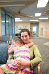 Adult woman holding child in a waiting room